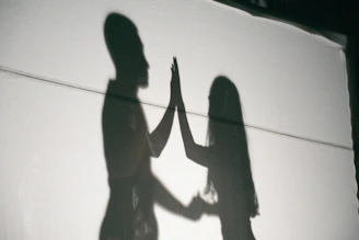 A shadow of two people holding hands