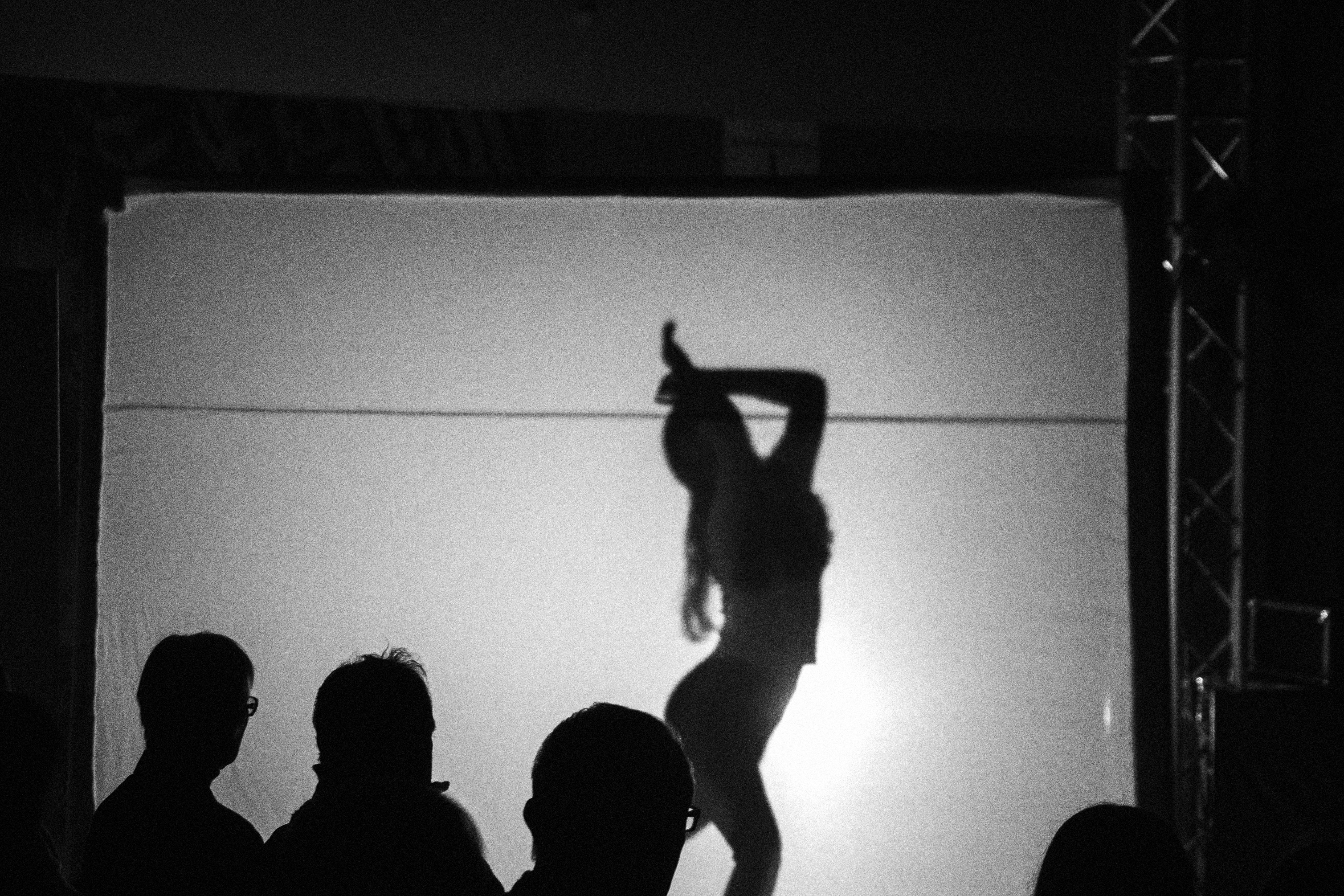 A woman standing on top of a stage in front of a crowd