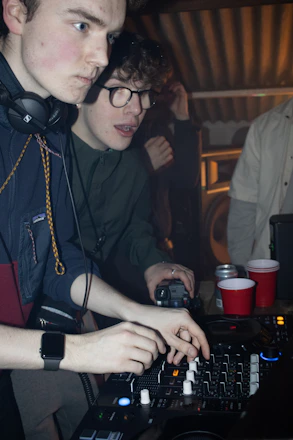 A man in headphones is using a keyboard