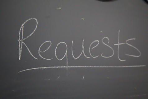 A chalkboard with the word request written on it
