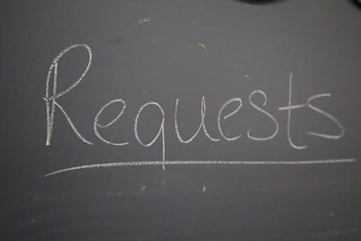 A chalkboard with the word request written on it