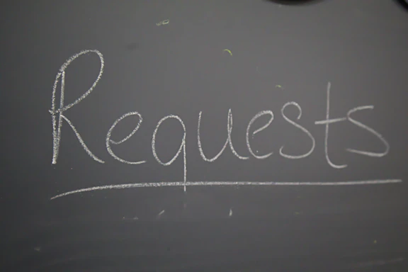 A chalkboard with the word request written on it