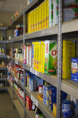 A shelf in a store filled with lots of food