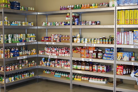 A large metal shelf filled with lots of food