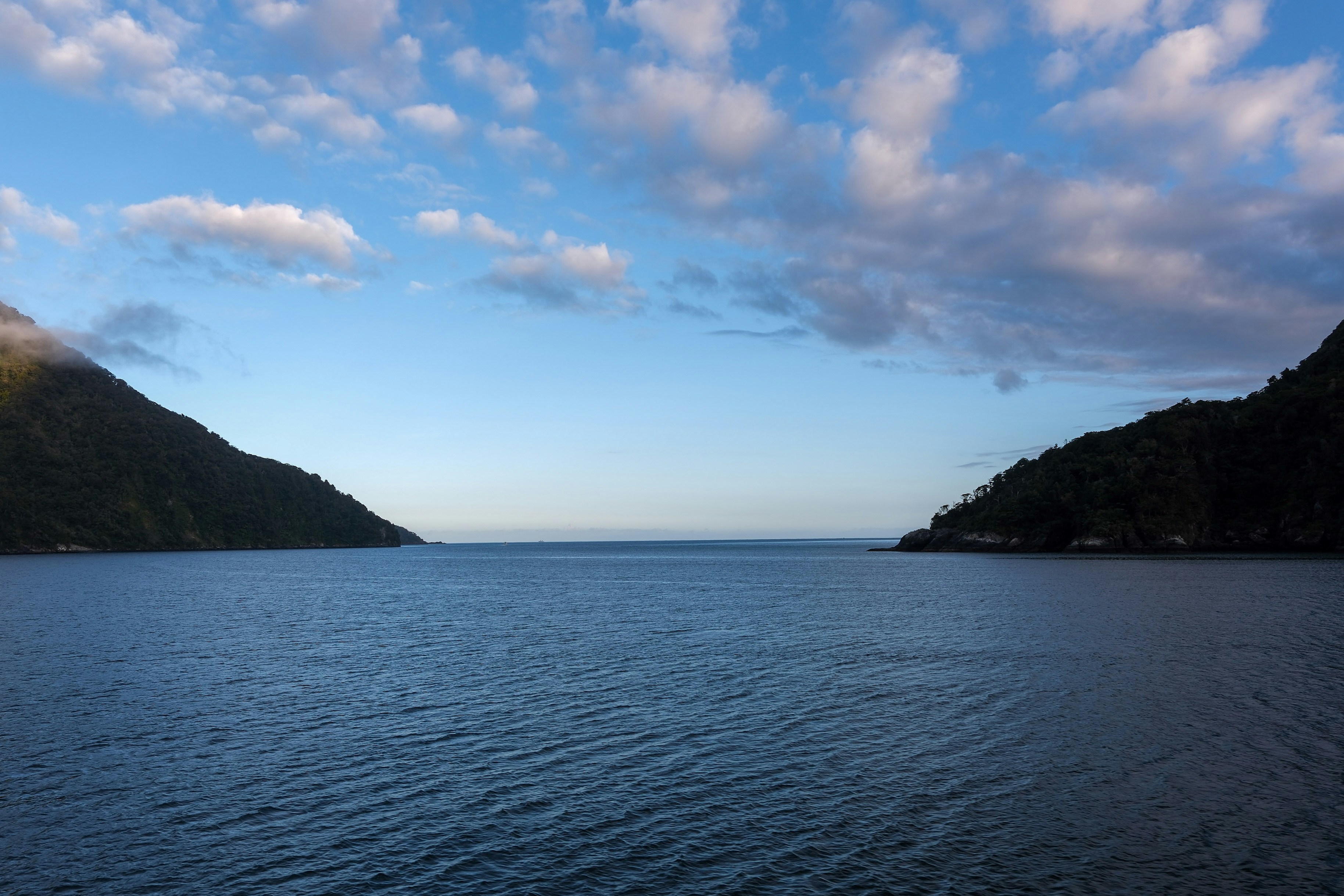 A large body of water surrounded by mountains