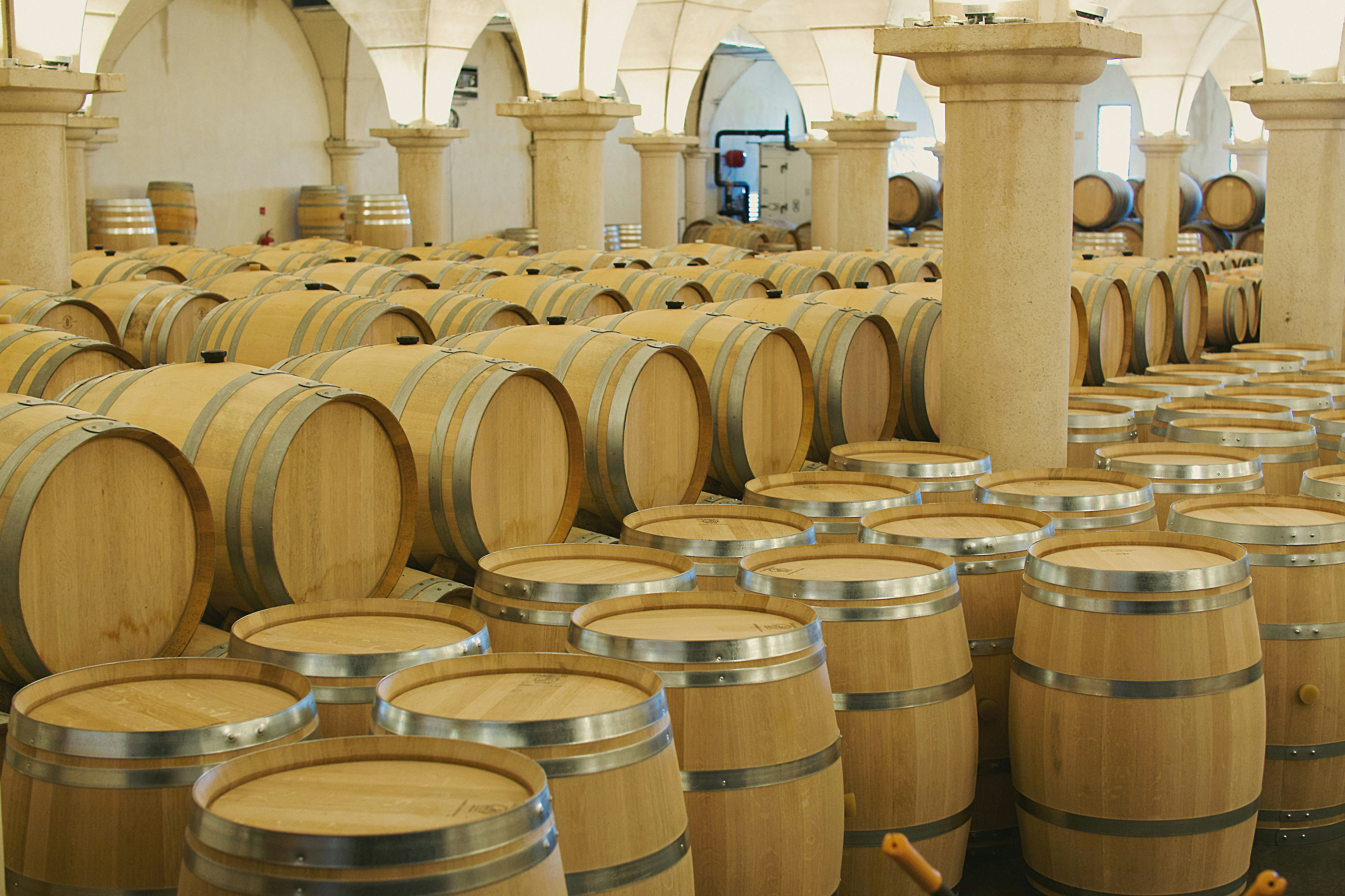 A large room filled with lots of wooden barrels