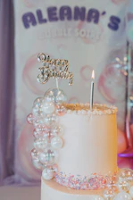 A white cake with a candle on top of it