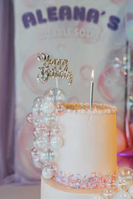 A white cake with a candle on top of it