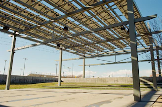 A large metal structure sitting on the side of a road
