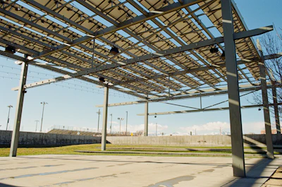 A large metal structure sitting on the side of a road