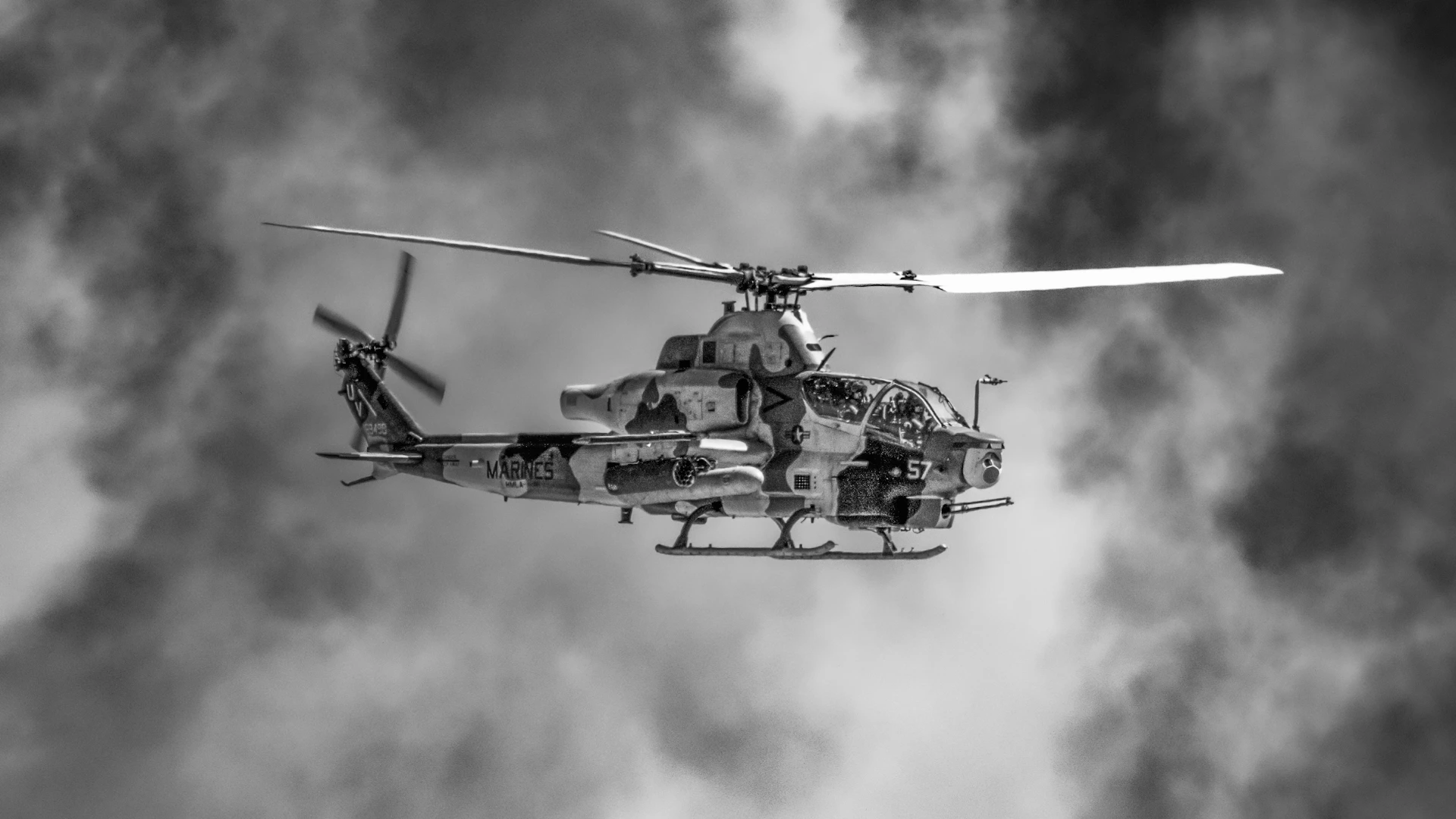 A black and white photo of a helicopter in the air