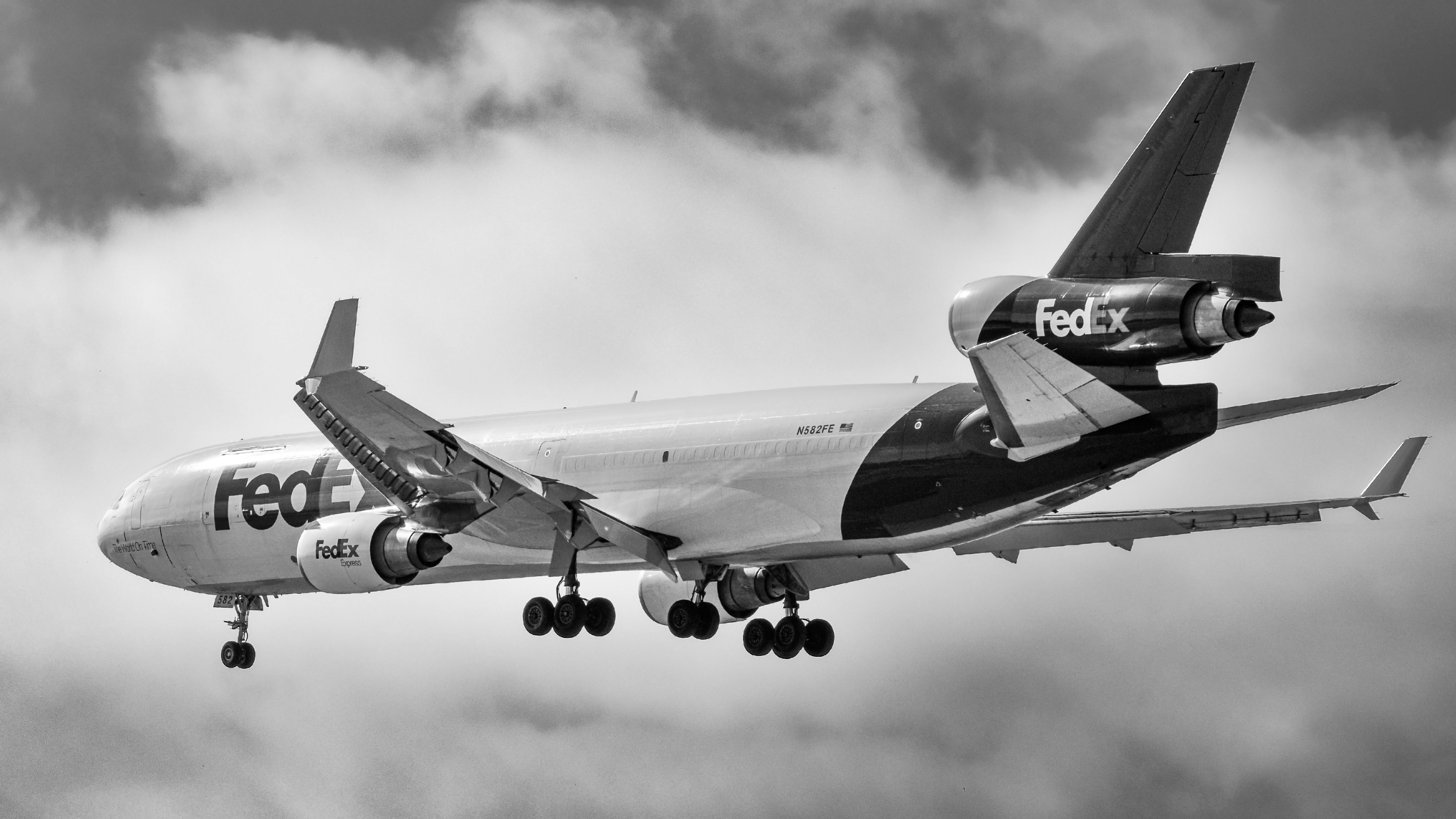 A large jetliner flying through a cloudy sky