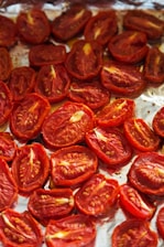 A pan filled with sliced tomatoes on top of a table