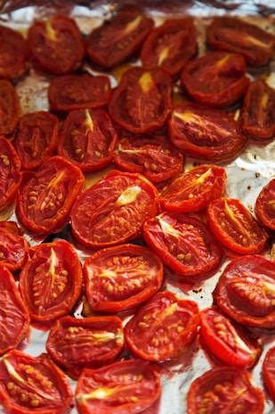 A pan filled with sliced tomatoes on top of a table