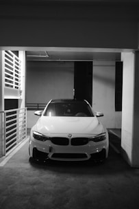 A white car parked in a parking garage