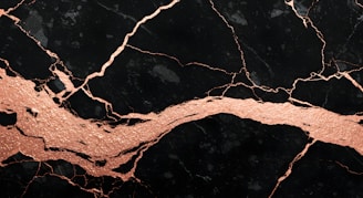 A close up of a black and gold marble texture