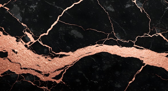 A close up of a black and gold marble texture