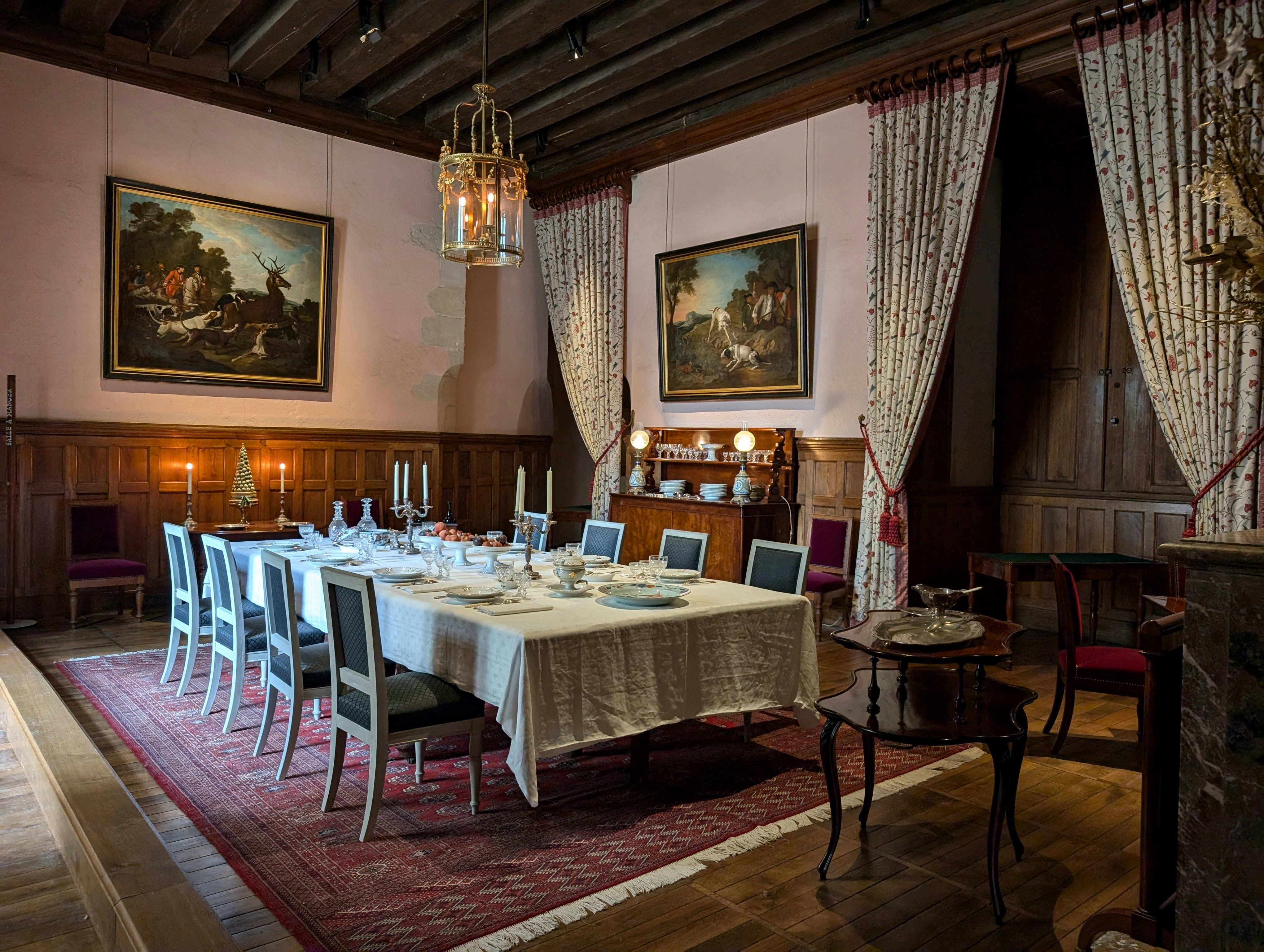A dining room with a table and chairs