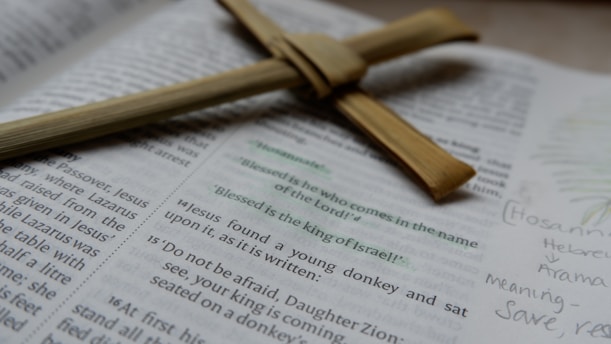 A wooden cross laying on top of an open bible