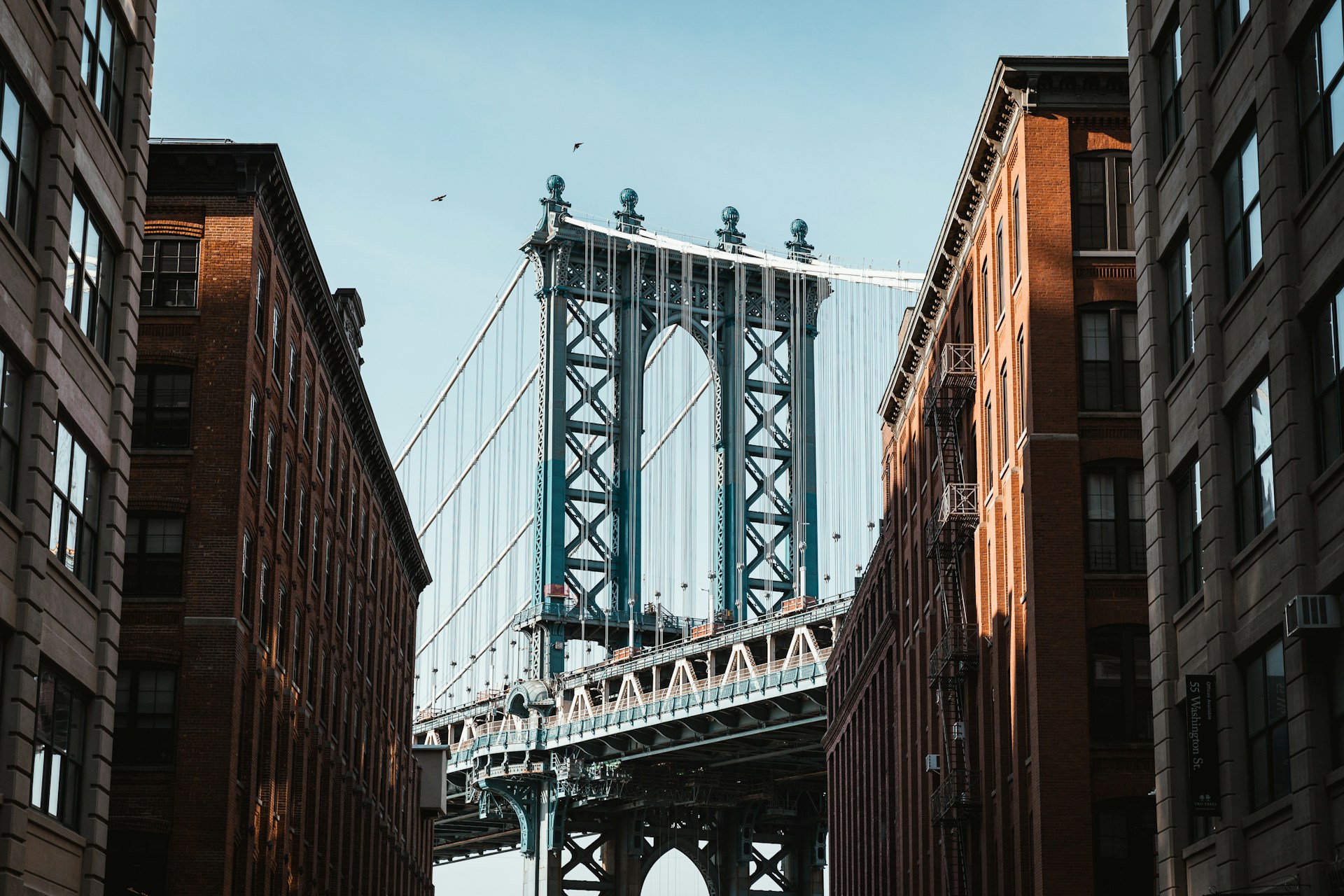 A view of a bridge from between two buildings