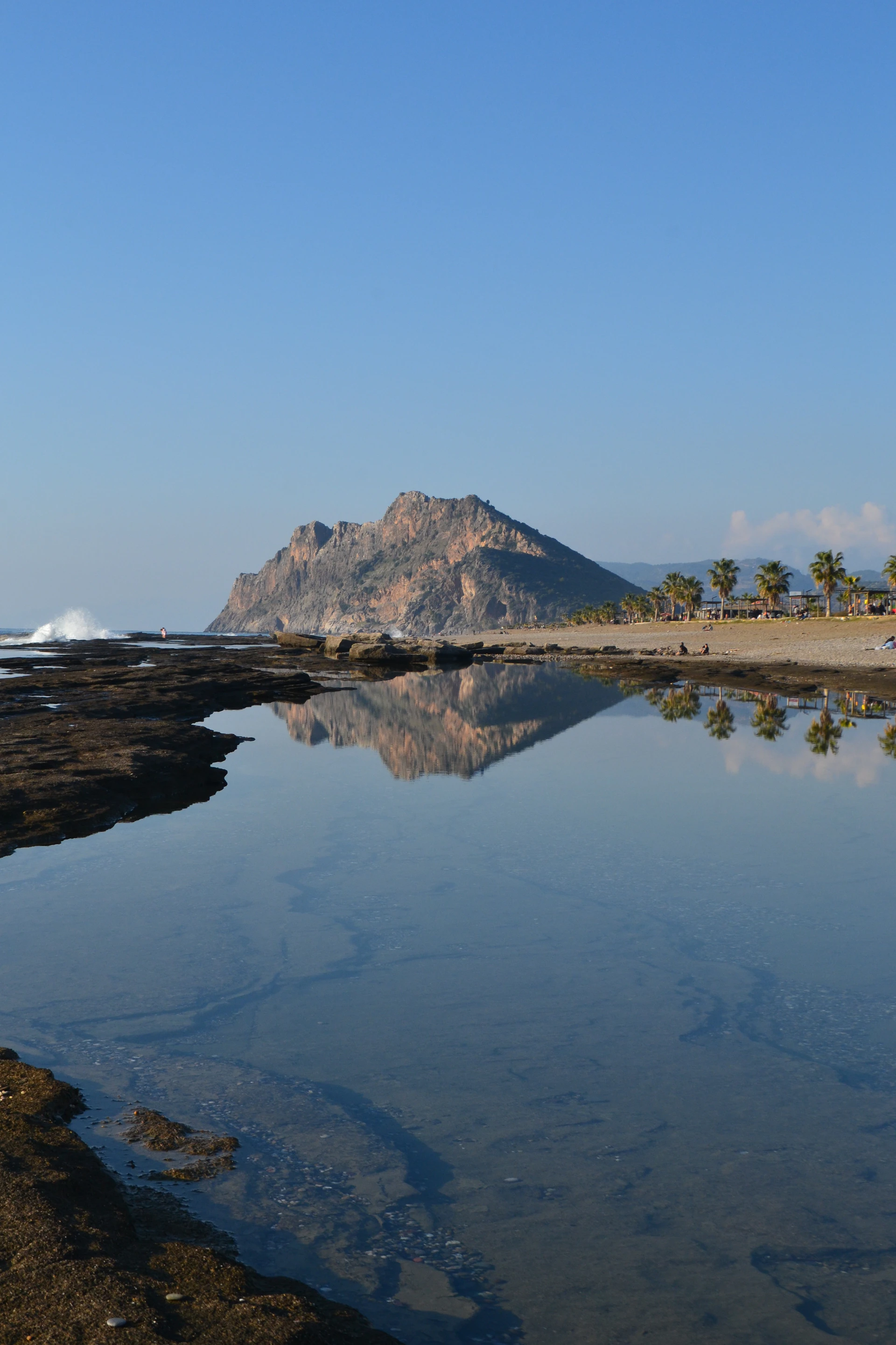 A body of water with a mountain in the background