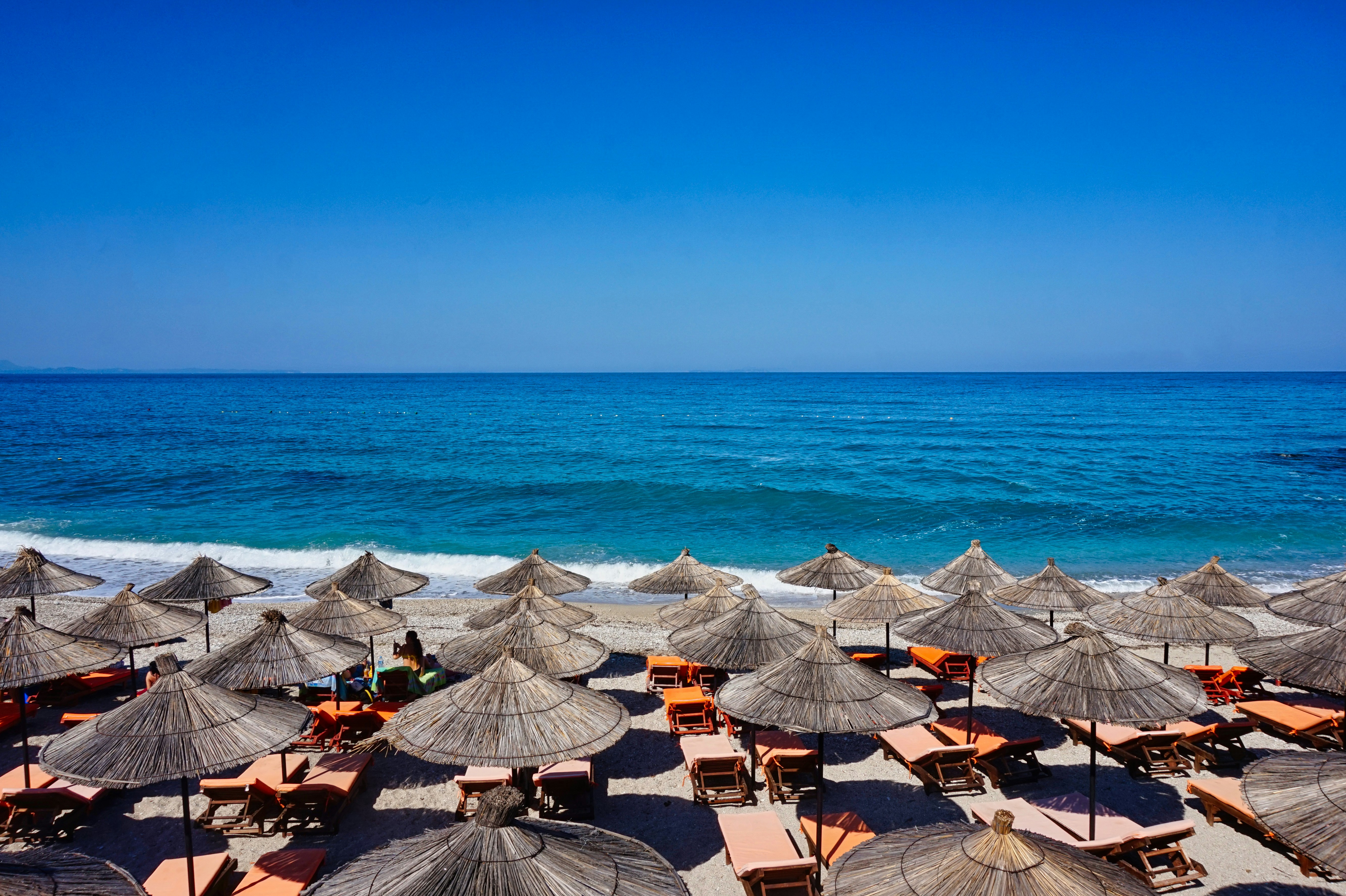 Beach bar with umbrellas and lounges at the Albanian Riviera during summer. When using my images please cite me as follows: Marie Volkert / Reiseblog Worldonabudget and link to my website: www.worldonabudget.de