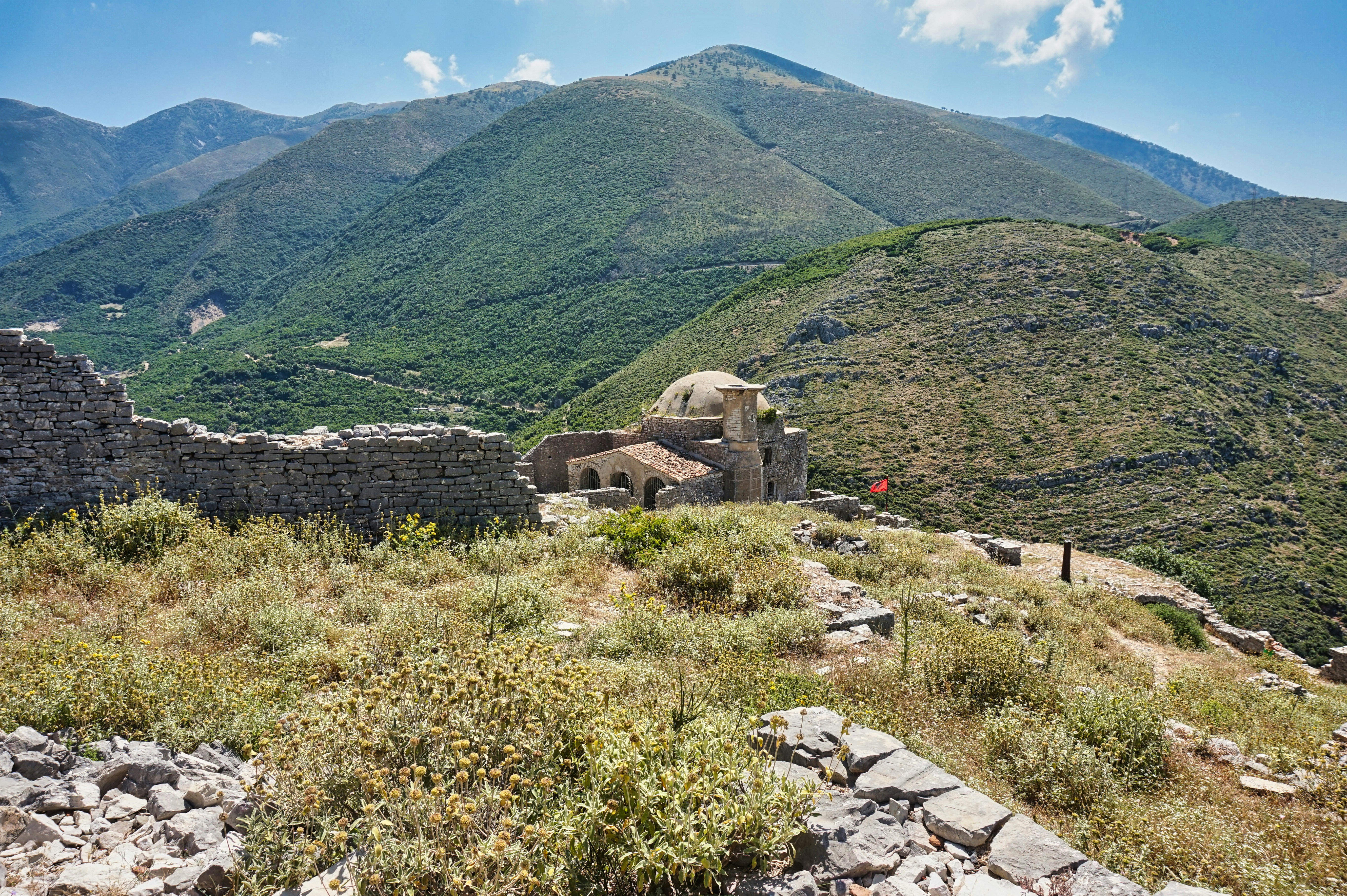 A view of a mountain with a house on top of it