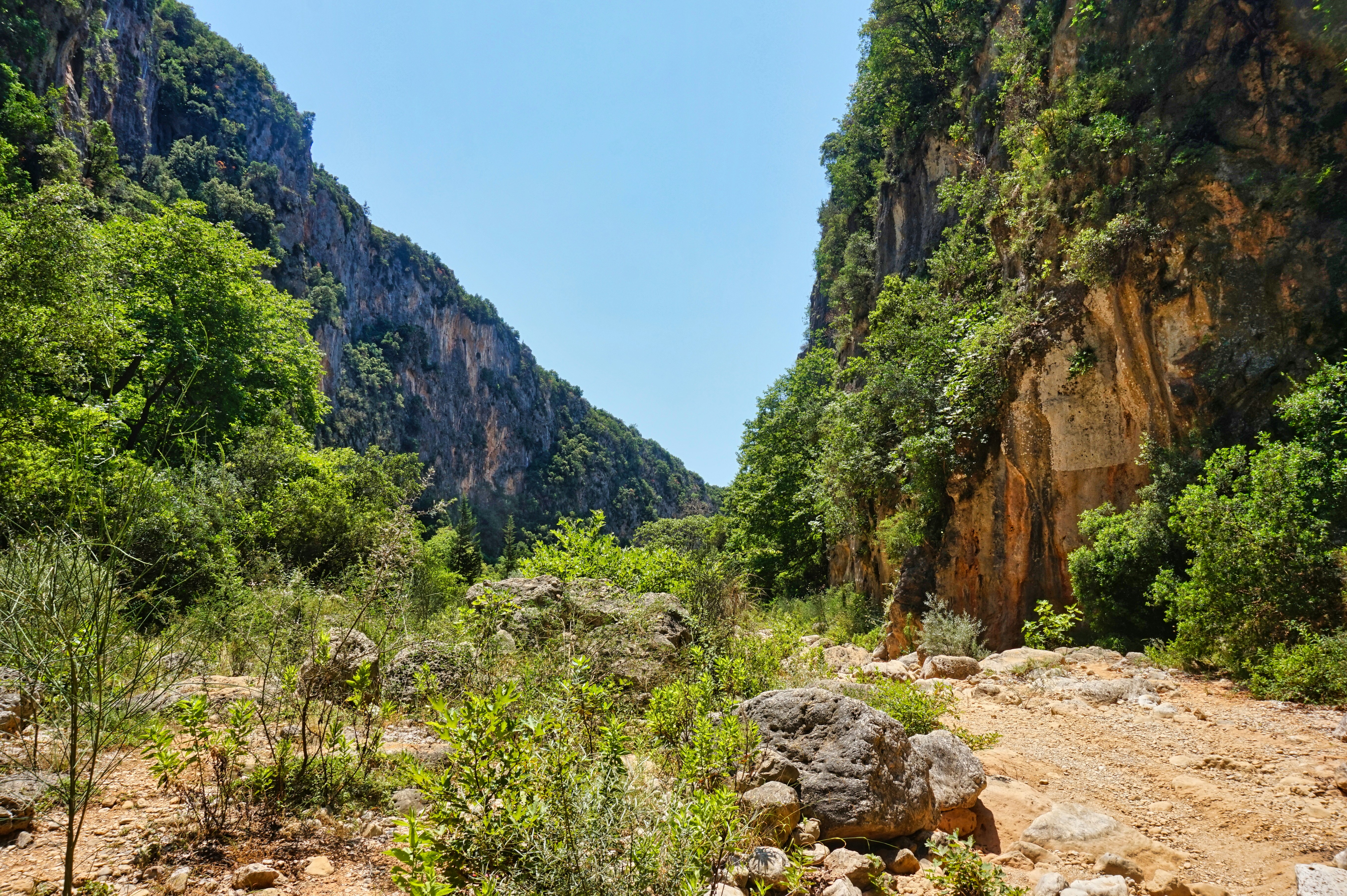 Hiker enjoying the breathtaking views at Gjipe Canyon