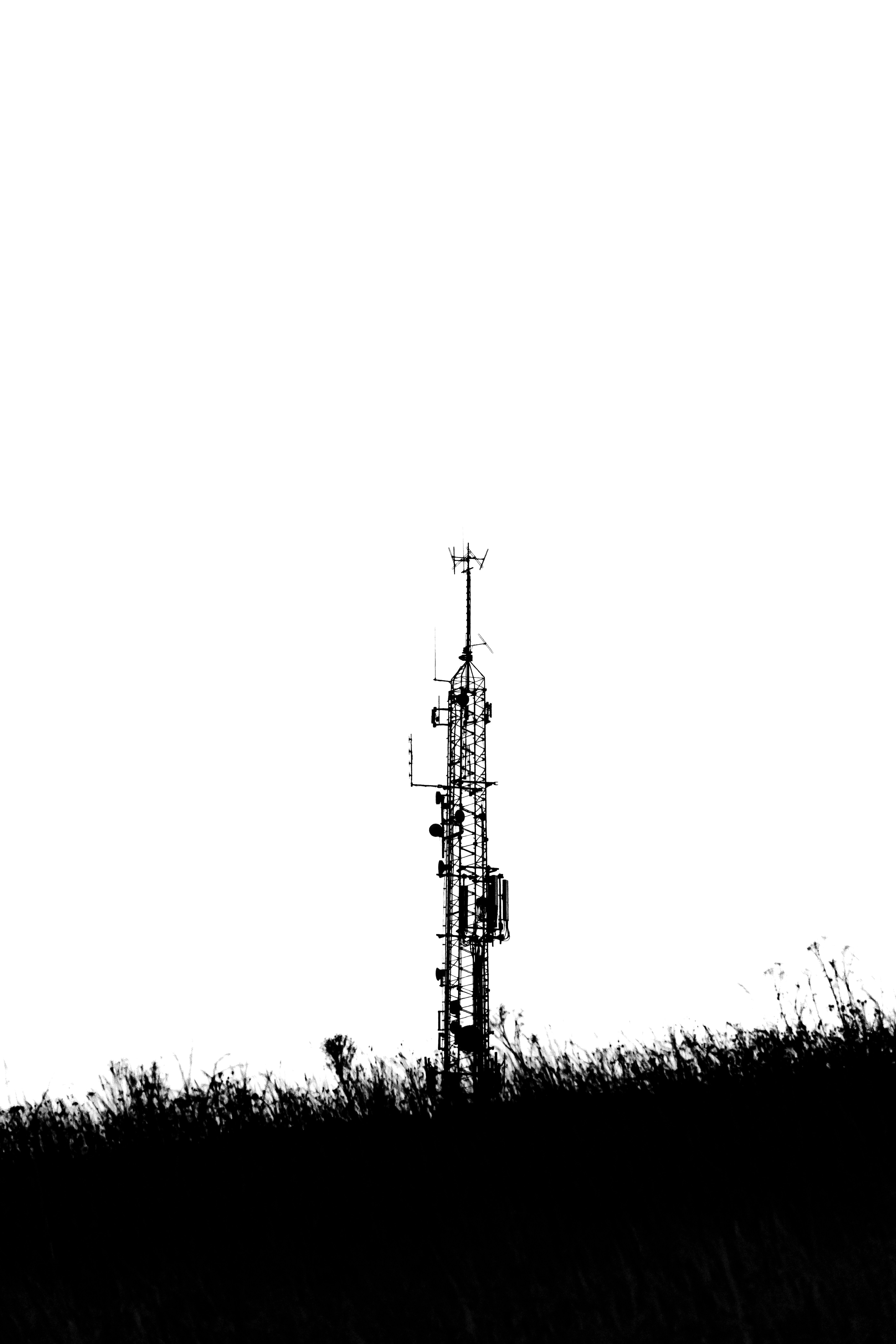 A black and white photo of a cell phone tower