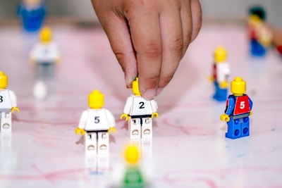 A person is playing a game of legos