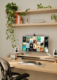 A desk with a computer monitor and keyboard