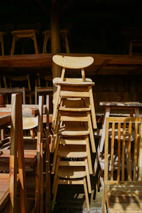 A group of wooden chairs sitting next to each other