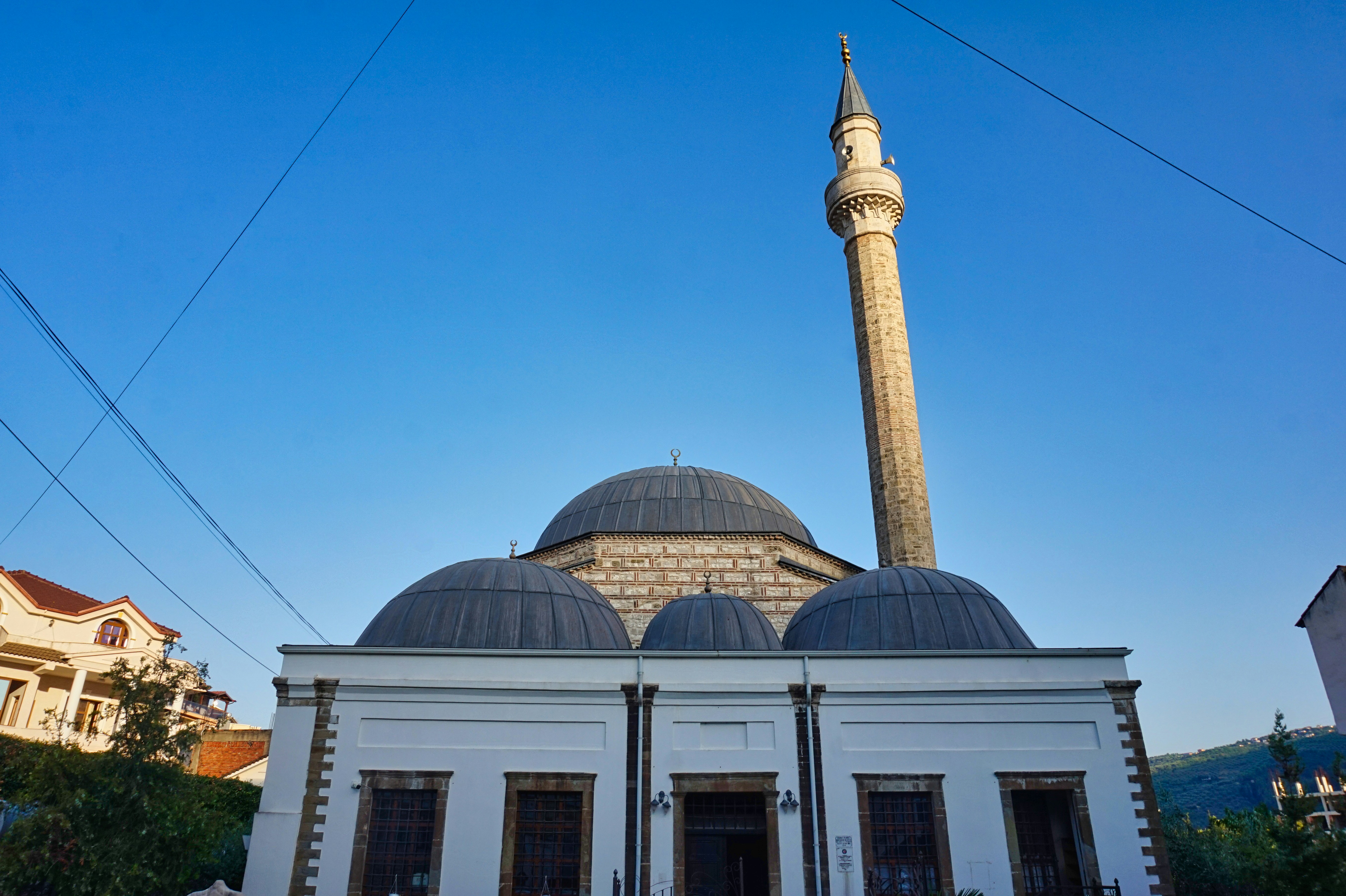 A large white building with a tall tower in the background