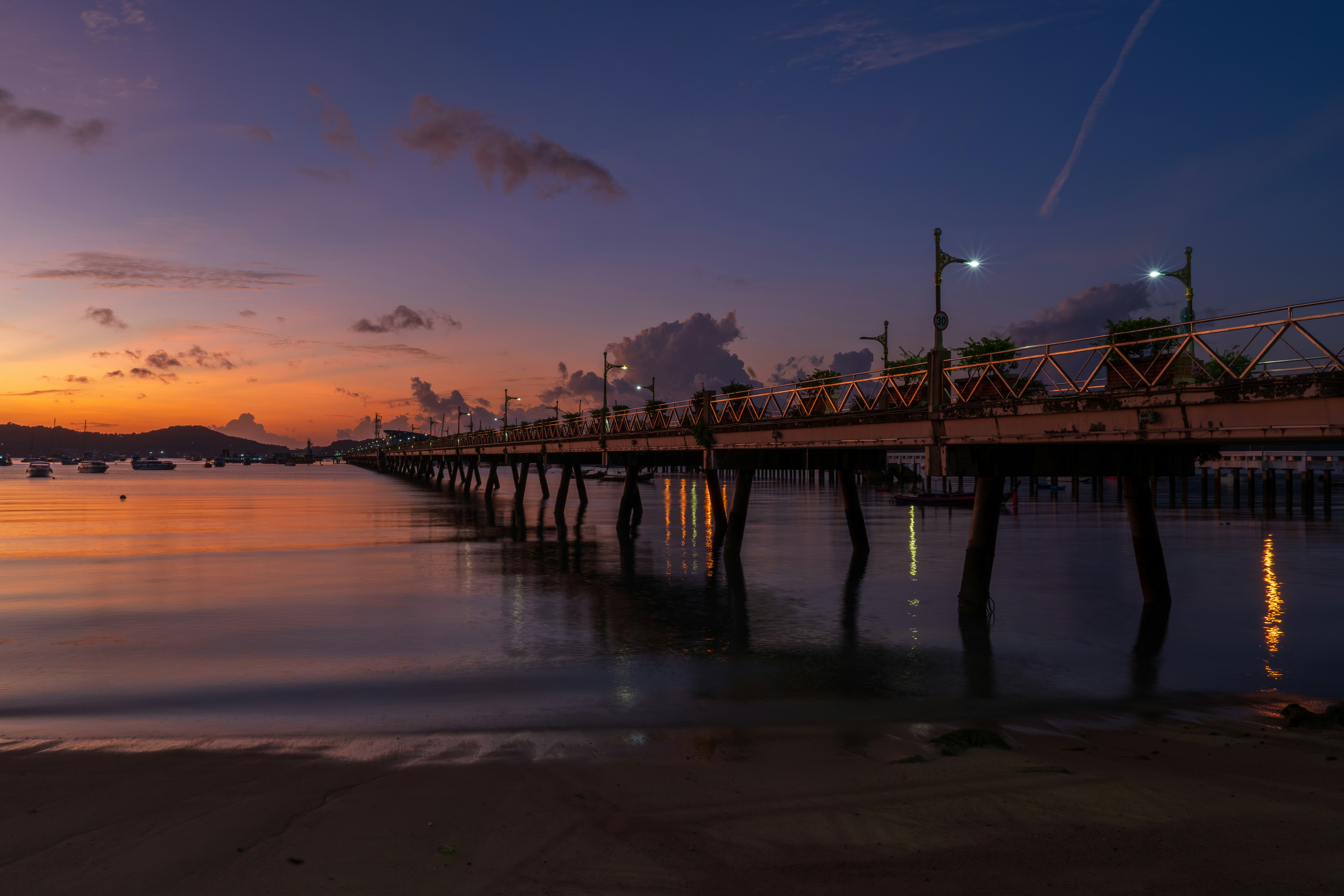 A pier with a sunset in the background