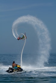 A man riding a jet ski while being pulled by a boat