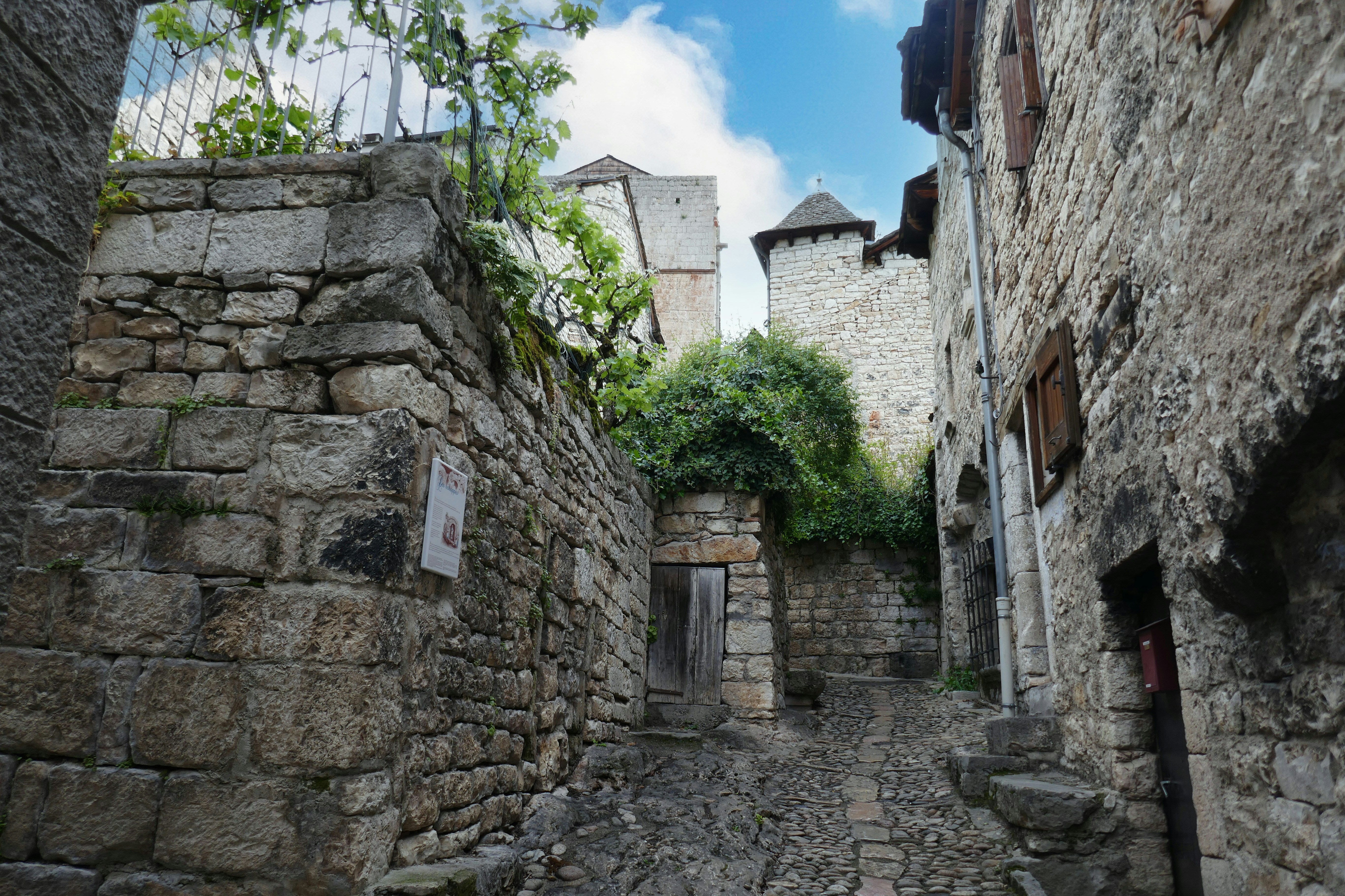 A narrow cobblestone street with stone buildings