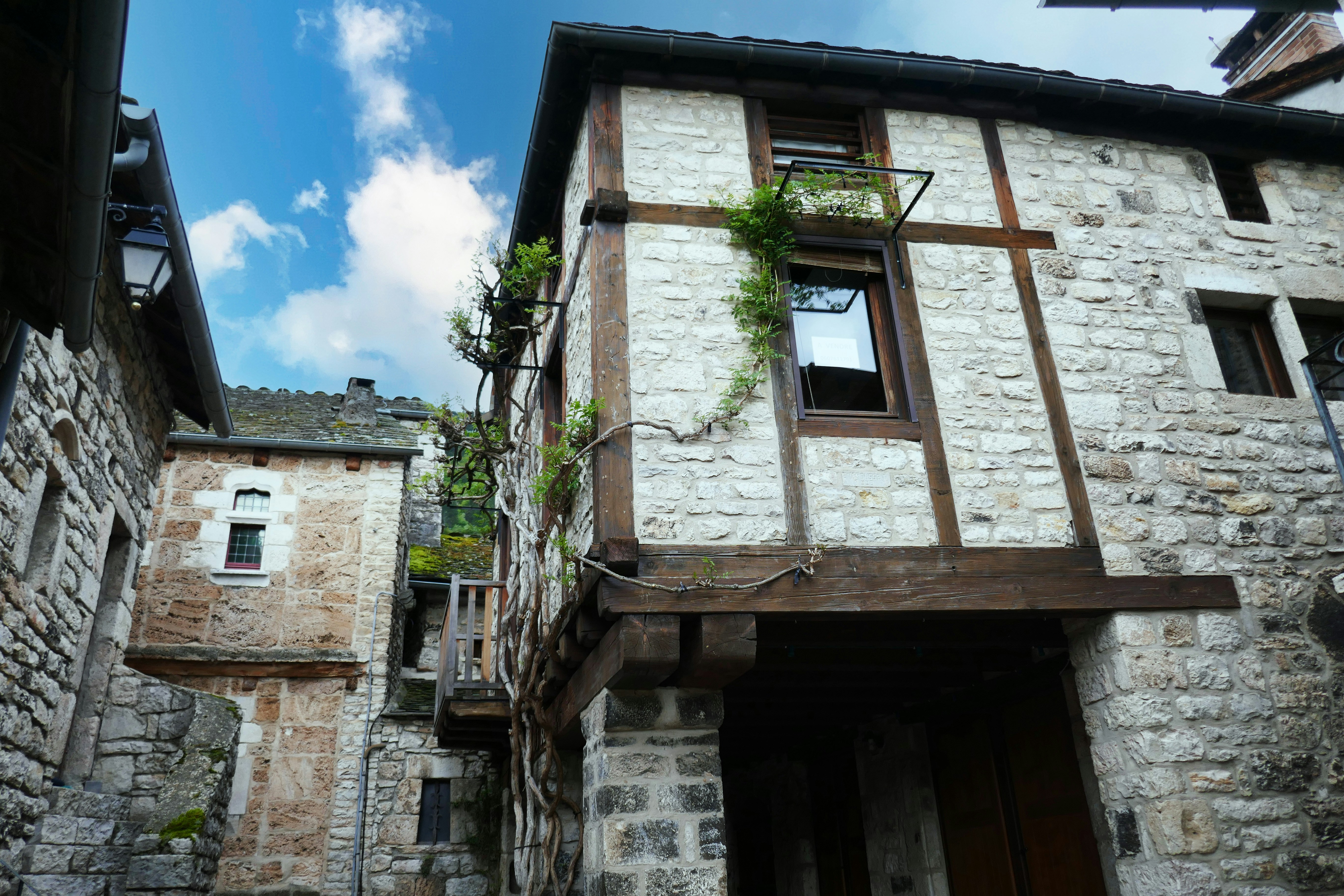 A stone building with a wooden door and windows