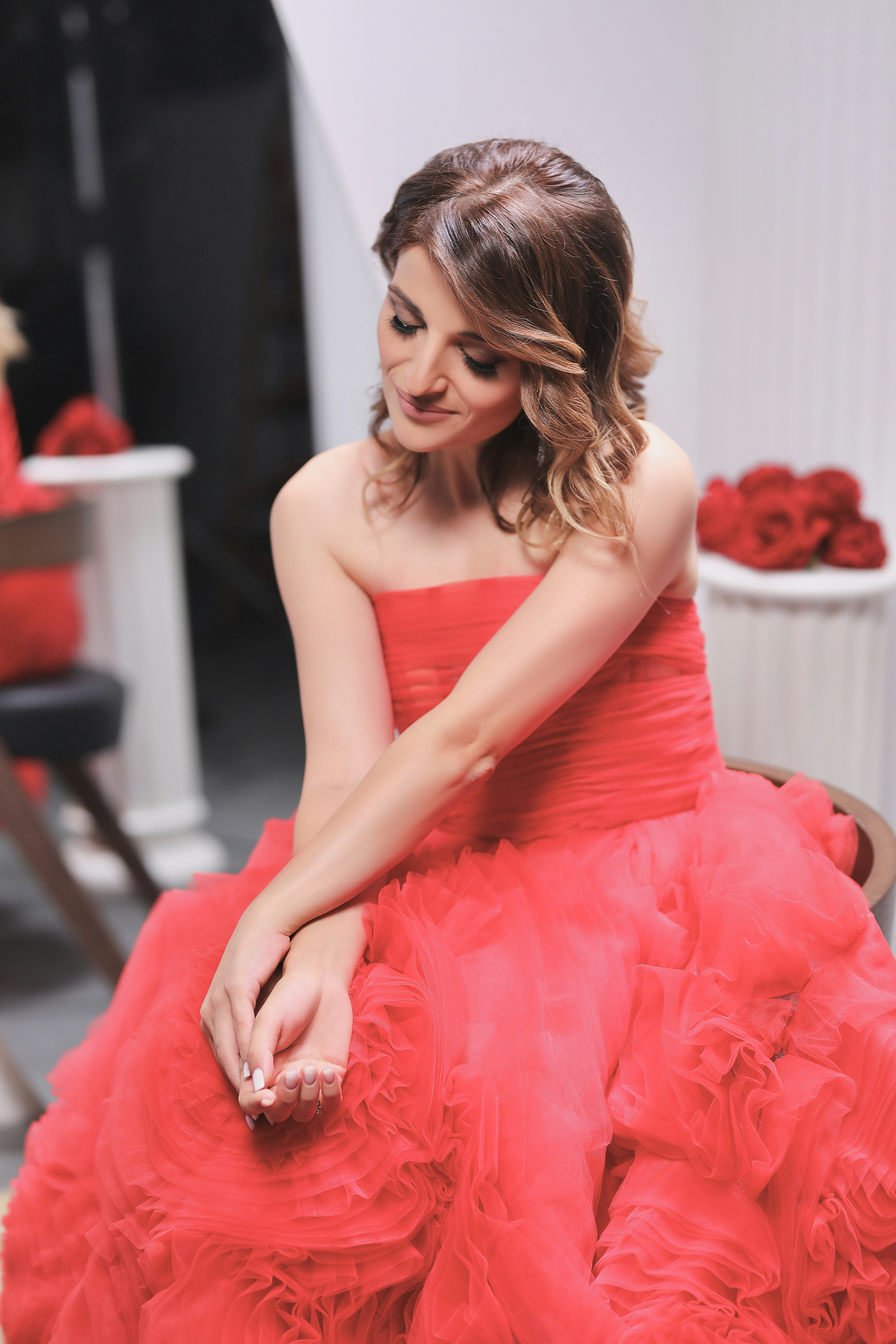 A woman in a red dress sitting on a chair photo – Free Ereván Image on ...