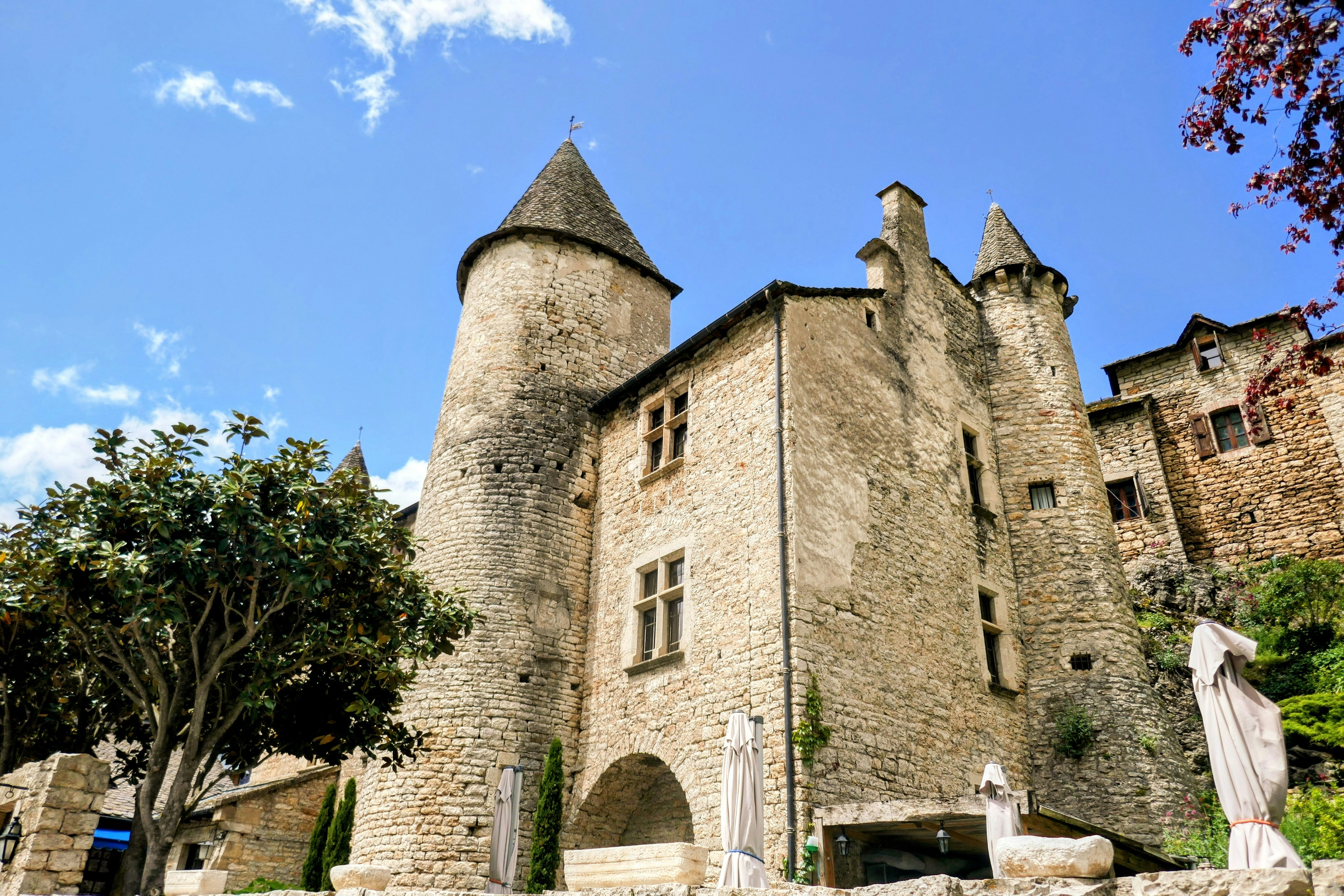 An old castle with statues in front of it