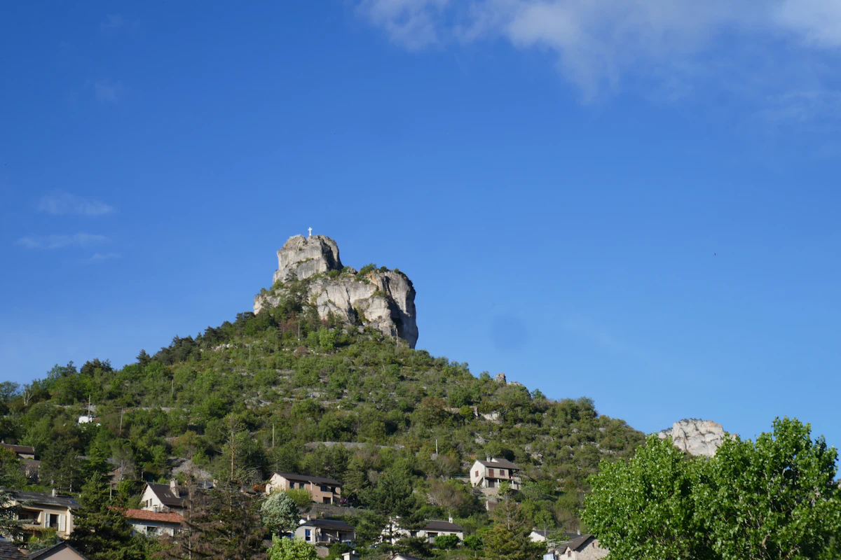 A limestone rock pinnacle above a village in the Gorges du Tarn