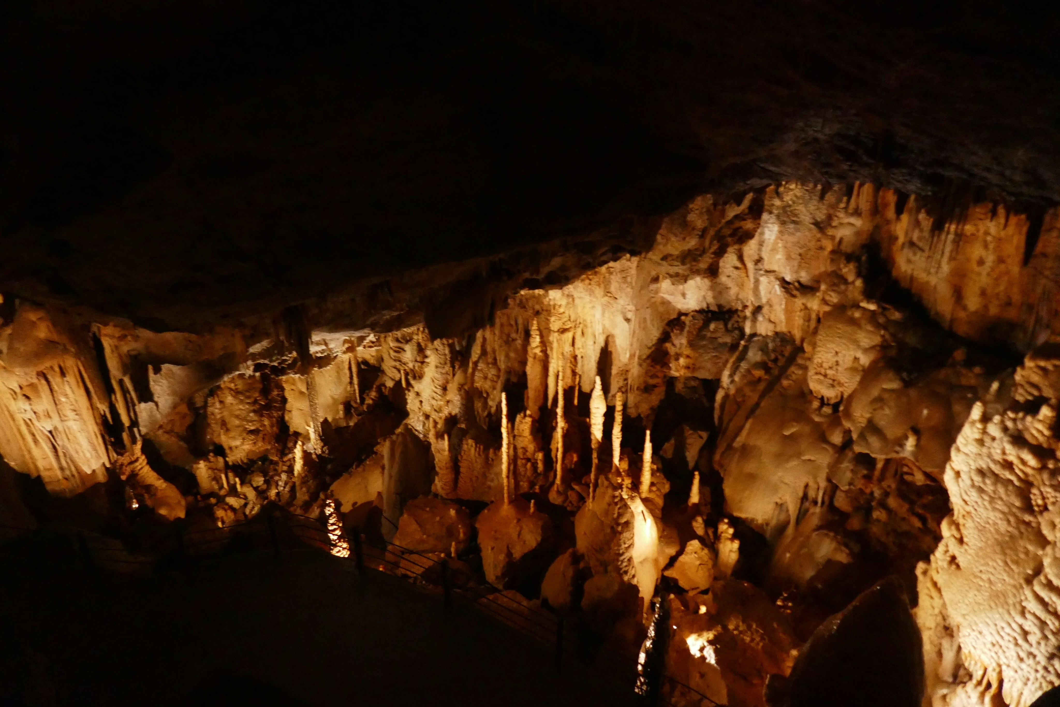 A group of people standing inside of a cave