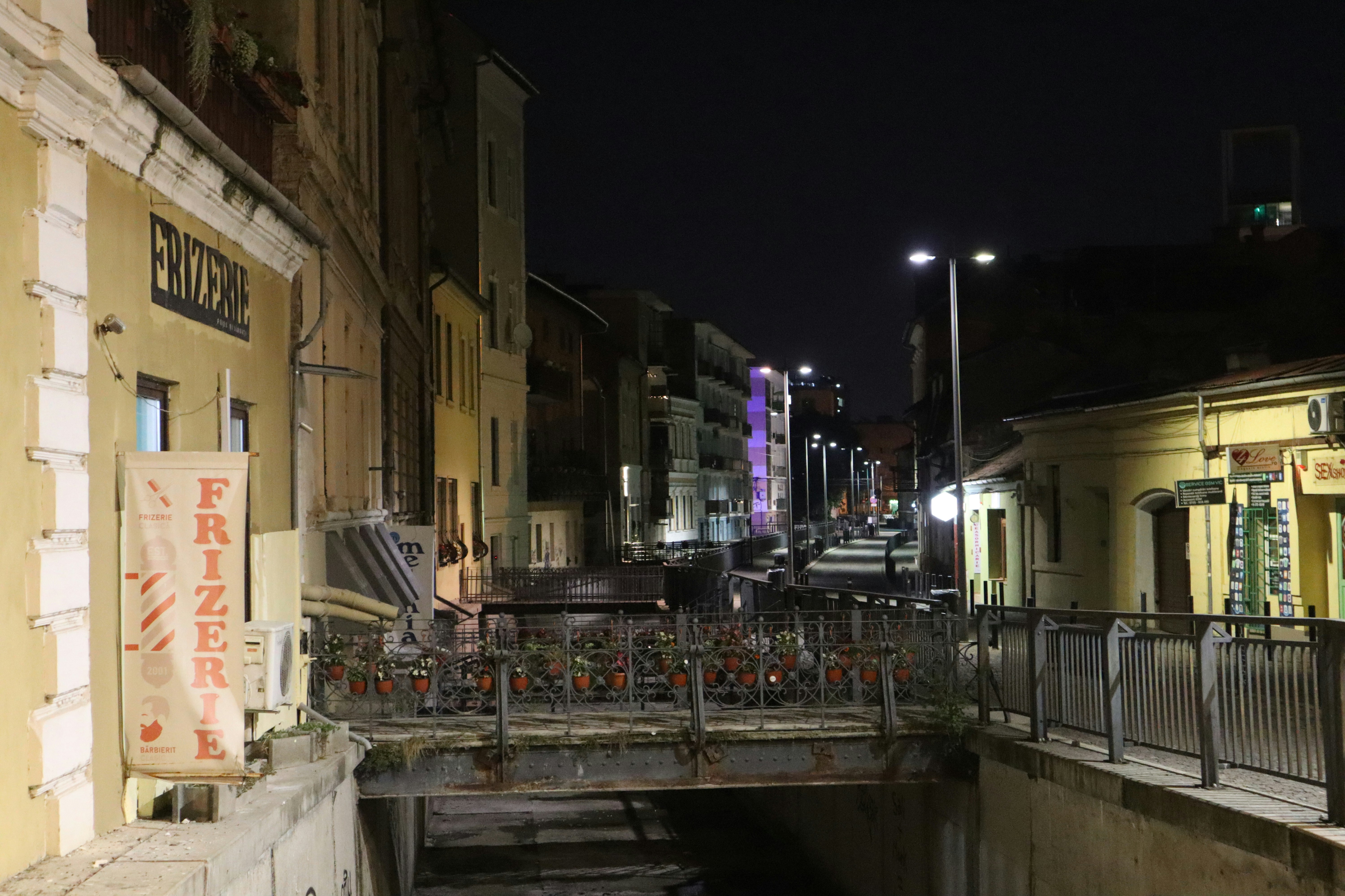 A bridge over a canal in a city at night
