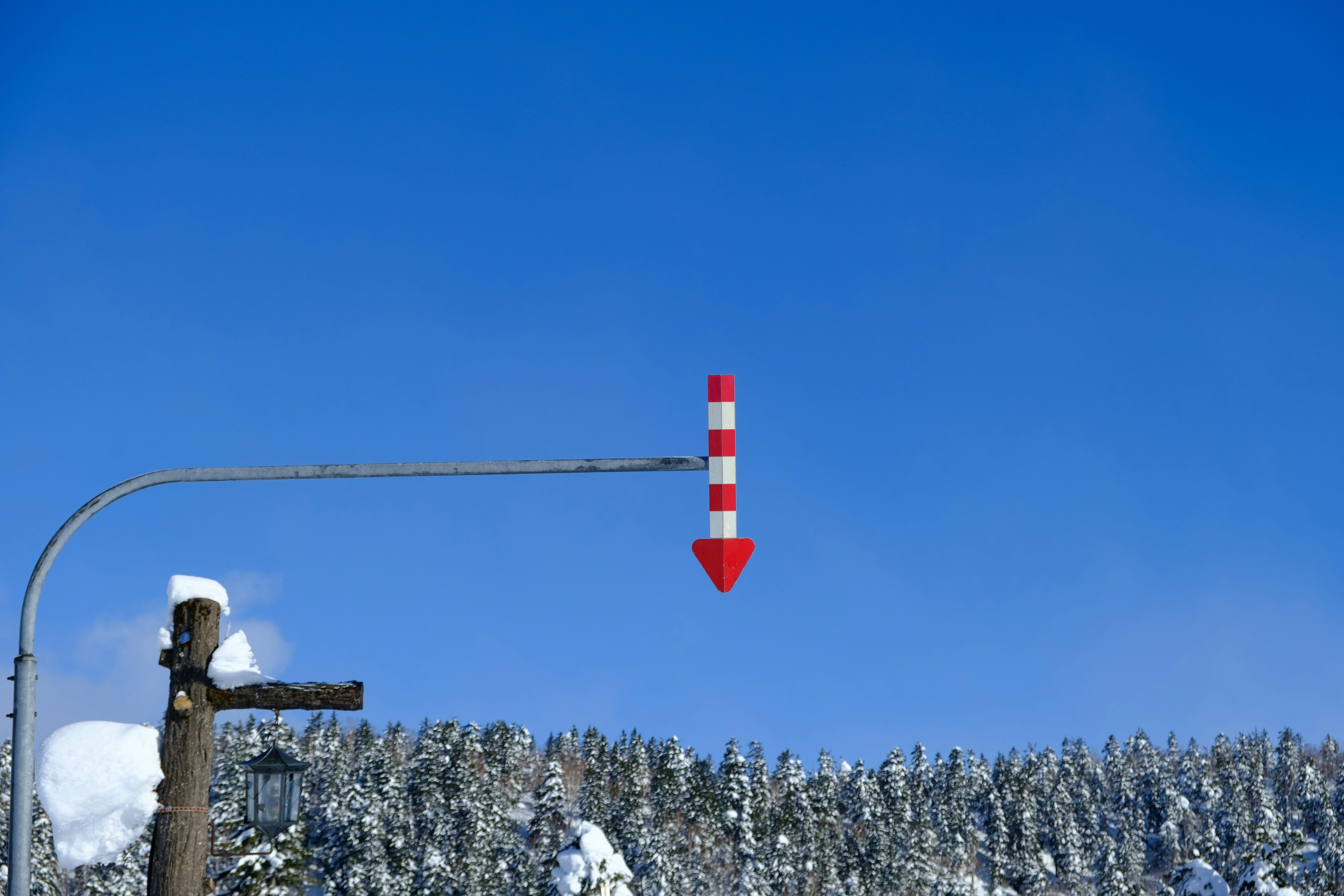 A red and white street light on a pole