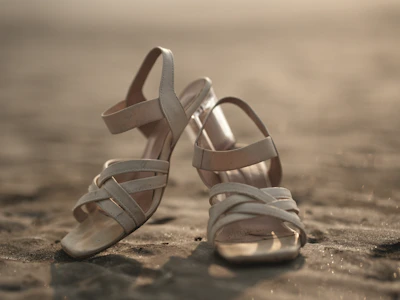 A pair of shoes sitting on top of a sandy beach