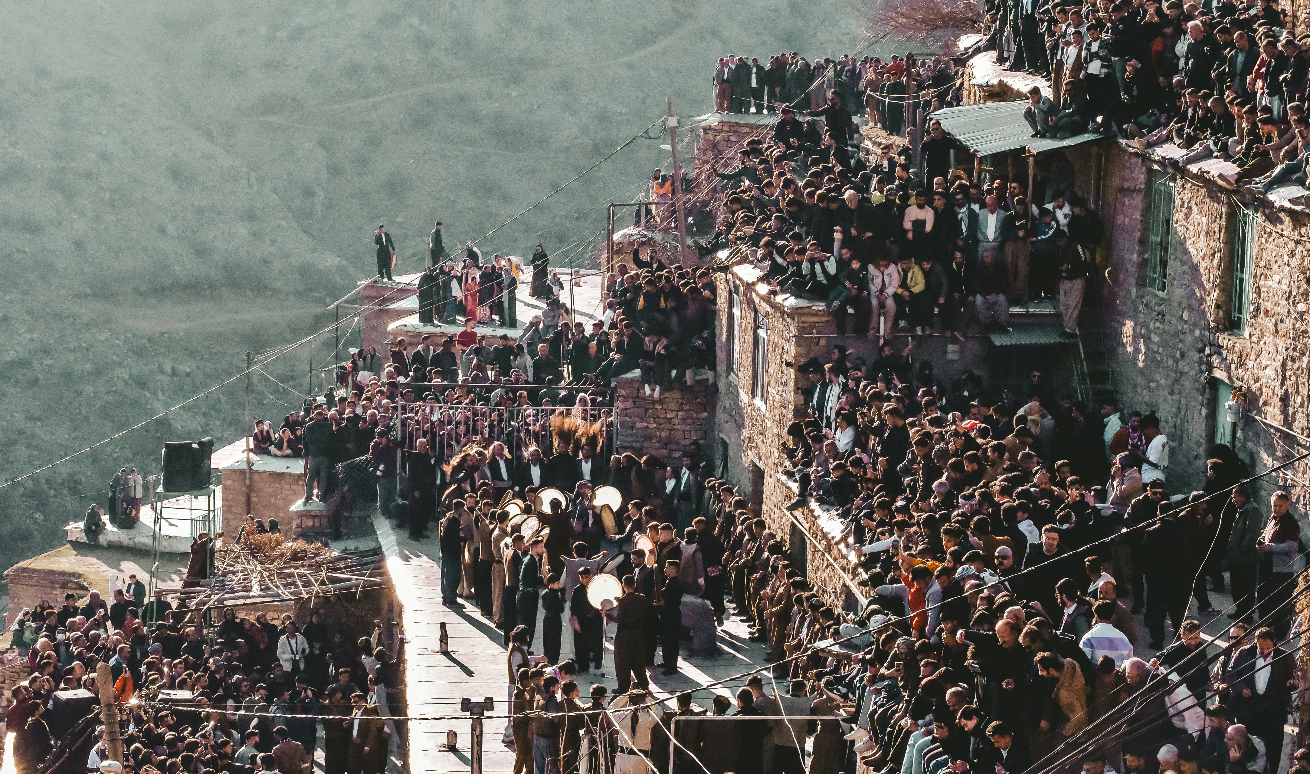 A crowd of people standing on top of a building