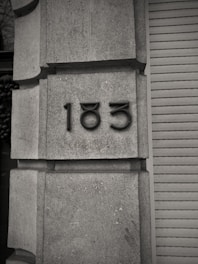 A black and white photo of a building with a number on it