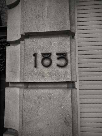 A black and white photo of a building with a number on it