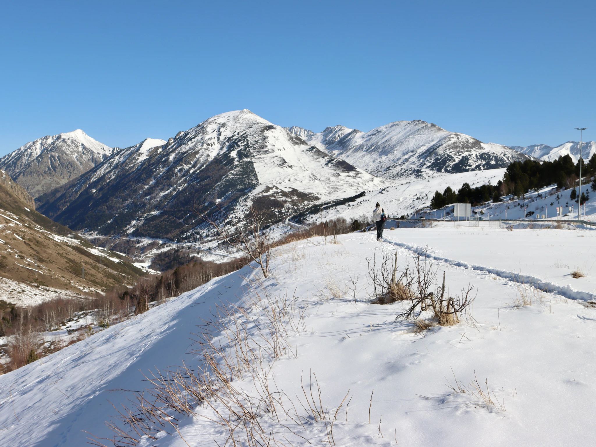 A snow-covered field below the mountains of Andorra, where skiing Arinsal means Pal too