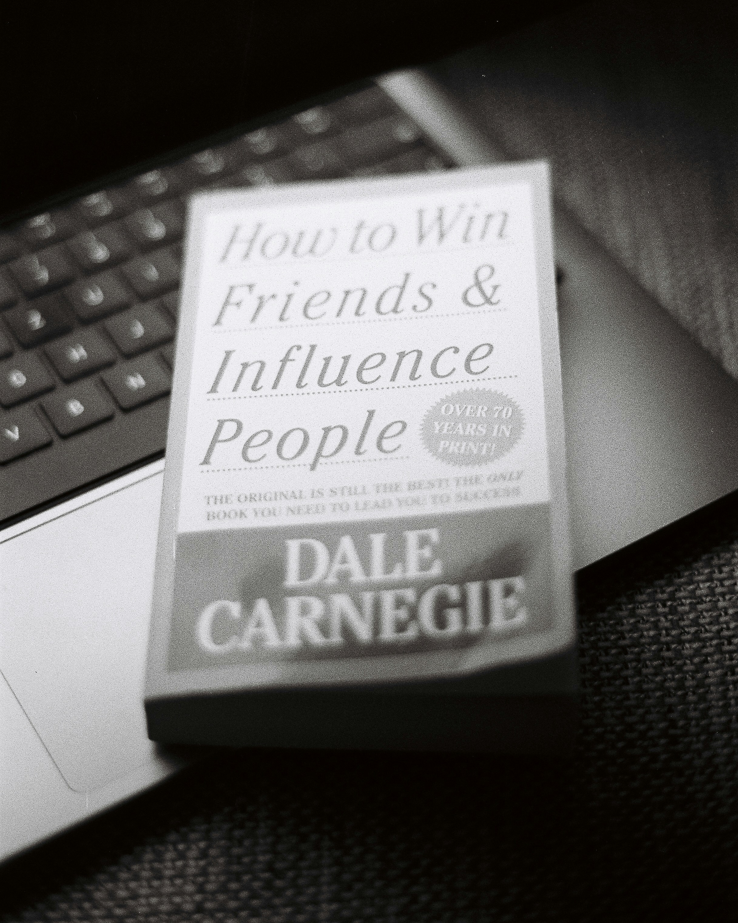 A book sitting on top of a laptop computer