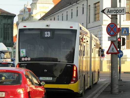 A city street filled with traffic next to tall buildings — Timișoara, Romania